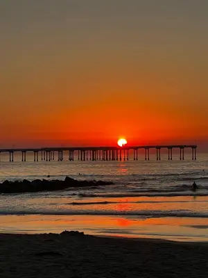 a sunset over the ocean with a pier at Charming Ocean Beach 2BR in San Diego