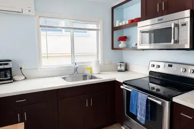 a kitchen with a sink and a stove and a window at Charming Ocean Beach 2BR in San Diego