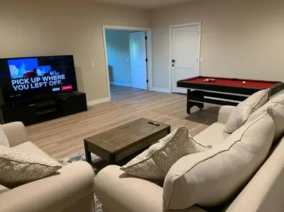 a living room with a couch and a pool table at New Constructed Home in Poway in Poway