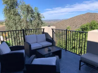 a balcony with couches and a table with a view at New Constructed Home in Poway in Poway