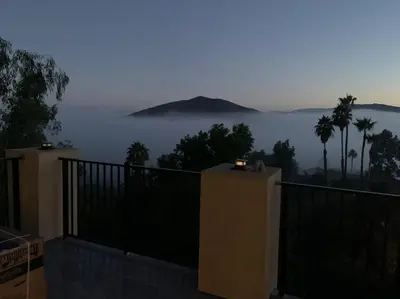 a balcony with a view of the ocean and palm trees at New Constructed Home in Poway in Poway
