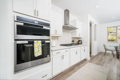 a kitchen with white cabinets and stainless steel appliances at Allura Champagne New in Wine Country Pool Game Room in Country Road Estates