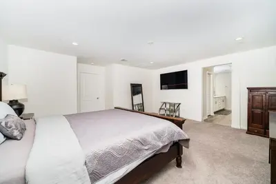 a bedroom with a bed and a flat screen tv at Allura Champagne New in Wine Country Pool Game Room in Country Road Estates