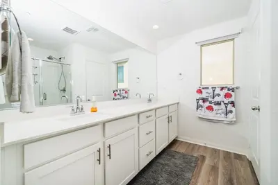 a white bathroom with two sinks and a mirror at Allura Champagne New in Wine Country Pool Game Room in Country Road Estates