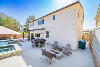 a patio with a table and chairs next to a building at Allura Champagne New in Wine Country Pool Game Room in Country Road Estates