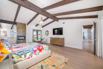 a bedroom with a bed and a tv in a room at Casa Via Zara - Sweeping Mountain Views with Pool in Fallbrook