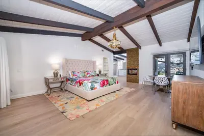 a bedroom with a bed and a desk in a room at Casa Via Zara - Sweeping Mountain Views with Pool in Fallbrook