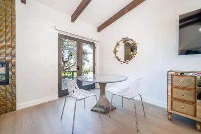 a dining room with a table and chairs and a dresser at Casa Via Zara - Sweeping Mountain Views with Pool in Fallbrook