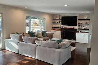 a living room with a large couch and a television at Anselmo in Mission Viejo