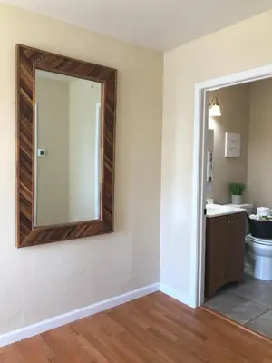 a bathroom with a mirror and a toilet at Calligraphy home with Private Deck near SDSU in San Diego