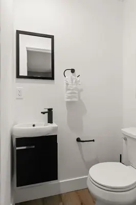 a bathroom with a white toilet and a sink at Brand New Coastal Contemporary in Pacific Beach in San Diego