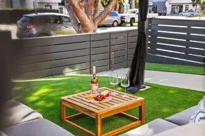 a table with a bottle of wine and wine glasses at Brand New Coastal Contemporary in Pacific Beach in San Diego