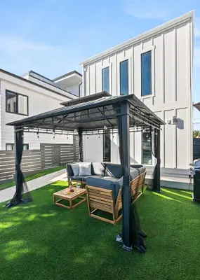 a gazebo on a lawn in front of a house at Brand New Coastal Contemporary in Pacific Beach in San Diego