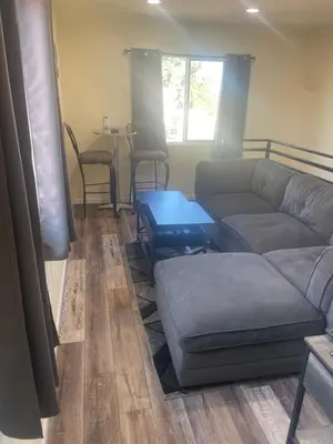 a living room with a couch and a table at Casa Mesa PLUS attached Studio & private Courtyard in San Diego