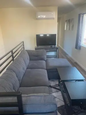 a living room with a couch and a tv at Casa Mesa PLUS attached Studio & private Courtyard in San Diego