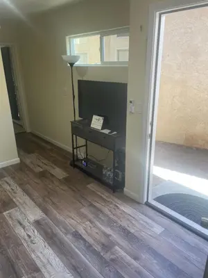 a living room with a table and a television at Casa Mesa PLUS attached Studio & private Courtyard in San Diego