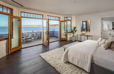 a bedroom with a bed and a view of the ocean at Spectacular La Jolla Cove Compound in San Diego