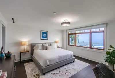 a bedroom with a large bed and a window at Spectacular La Jolla Cove Compound in San Diego