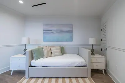 a white bedroom with a bed and two night stands at Spectacular La Jolla Cove Compound in San Diego