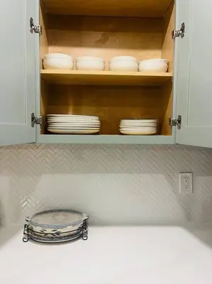 a kitchen cabinet with plates and dishes in it at NEW CA Coastal Beauty 6 mins to Imperial Beach in San Diego