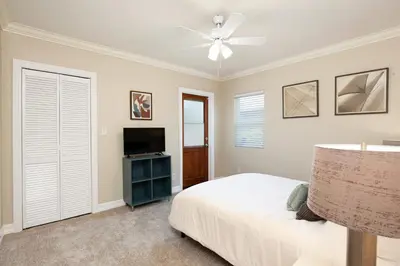 a bedroom with a bed and a flat screen tv at Hillcrest 3 bedroom charming private home by shops & restaurants in San Diego
