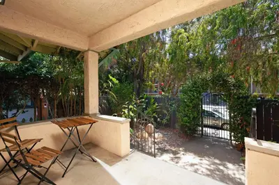 a porch with chairs and a fence and a gate at Hillcrest 3 bedroom charming private home by shops & restaurants in San Diego