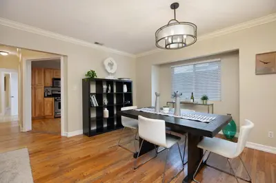 a dining room with a table and white chairs at Hillcrest 3 bedroom charming private home by shops & restaurants in San Diego