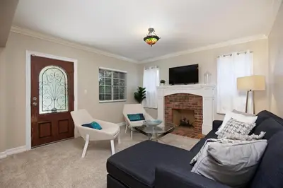 a living room with a couch and a fireplace at Hillcrest 3 bedroom charming private home by shops & restaurants in San Diego