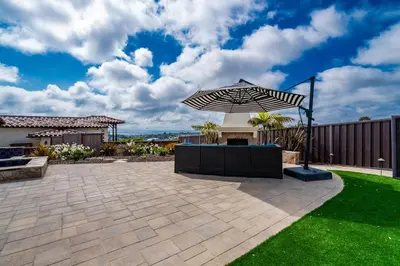 a patio with an umbrella in a yard at Spanish Dream with Ocean Views in Encinitas
