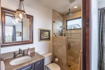 a bathroom with a toilet and a sink and a shower at Spanish Dream with Ocean Views in Encinitas