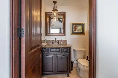 a bathroom with a sink and a toilet and a mirror at Spanish Dream with Ocean Views in Encinitas