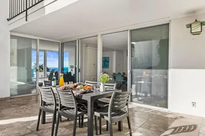 a dining room with a table and chairs at Sea Serenity Coastline Views and Pool in San Diego