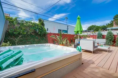 a hot tub in a backyard with a patio at Shores Perfection in San Diego