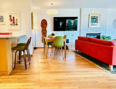 a living room with a red couch and a table at Shores Perfection in San Diego