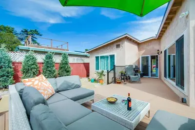 a patio with a couch and a table at Shores Perfection in San Diego