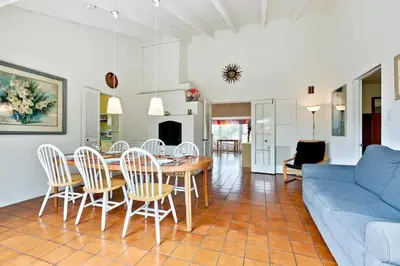 a living room with a table and chairs and a blue couch at PuertAzul in San Diego