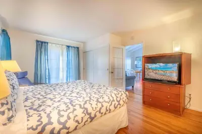 a bedroom with a bed and a flat screen tv at PuertAzul in San Diego