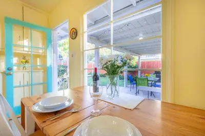 a dining room with a table with a vase of flowers at PuertAzul in San Diego