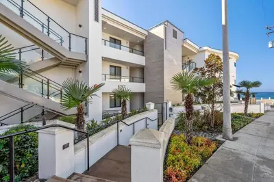 an exterior view of a building with palm trees at Blissful Retreat in San Diego