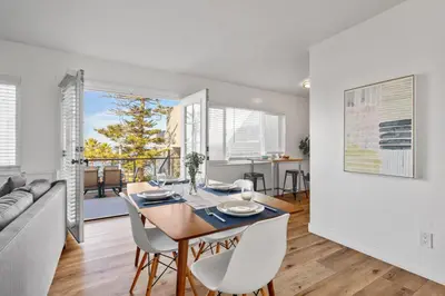 a dining room and living room with a table and chairs at Coastal Overlook in San Diego