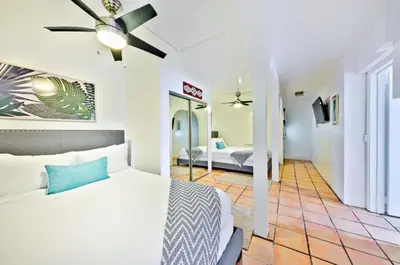 a bedroom with a bed and a ceiling fan at Coastal Overlook in San Diego