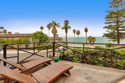 a balcony with chairs and a view of the ocean at Coastal Overlook in San Diego