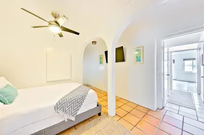a bedroom with a bed and a ceiling fan at Coastal Overlook in San Diego