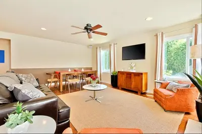 a living room with a couch and a ceiling fan at Sandy Shores Beach House in San Diego