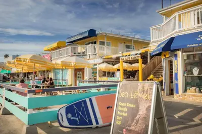 a surfboard sitting on a railing next to a building at Sandy Shores Beach House in San Diego