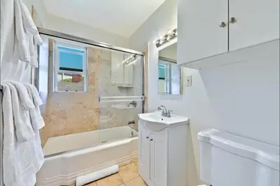 a bathroom with a tub and a sink and a toilet at Coastal Sunsets in San Diego