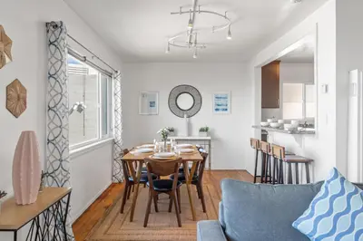 a dining room and kitchen with a table and chairs at Coastal Sunsets in San Diego