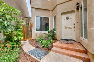 a home with a white door and a walkway at Village and Views in San Diego