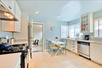 a kitchen with a table and a dining room at Sand Patch in San Diego