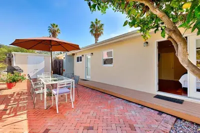 a patio with a table and an umbrella at Sand Patch in San Diego